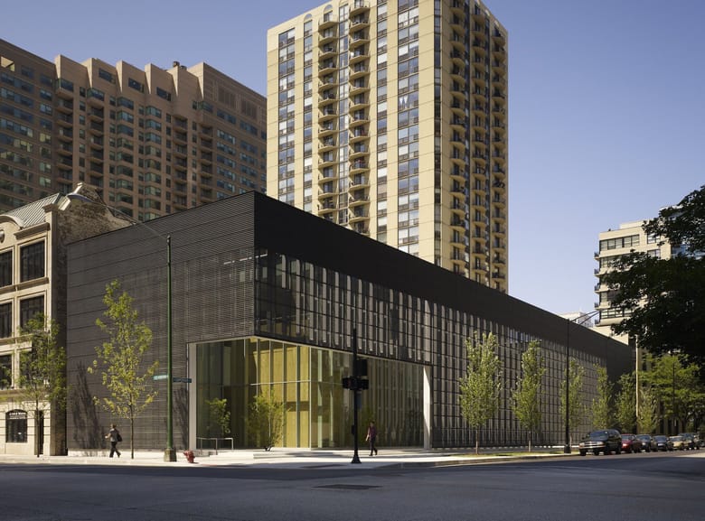 Exterior corner view of modern building with dark metal frame.